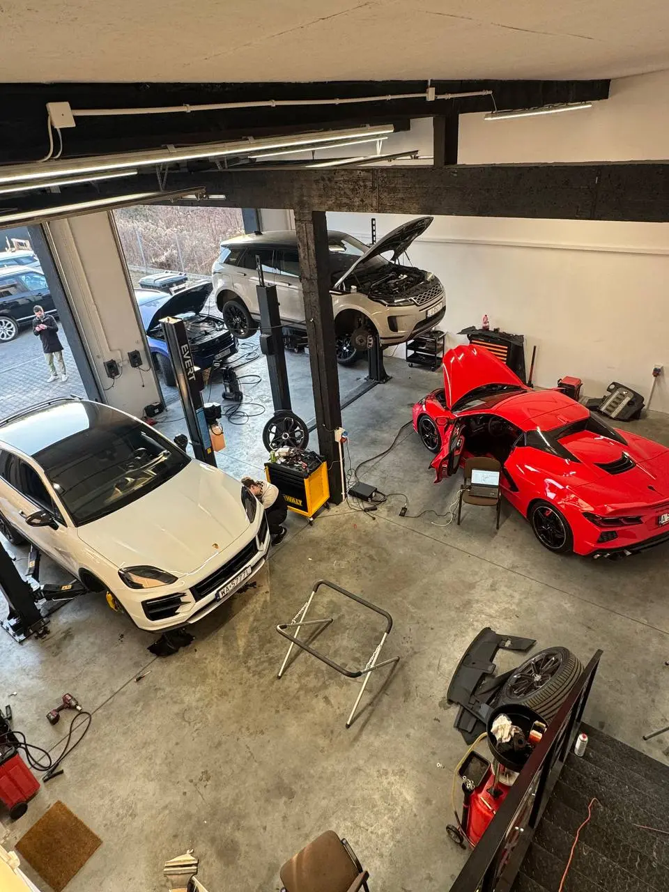 Overhead view of the Redlines service hall with cars on lifts