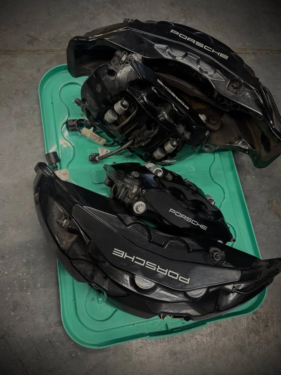 Porsche brake calipers on a service tray